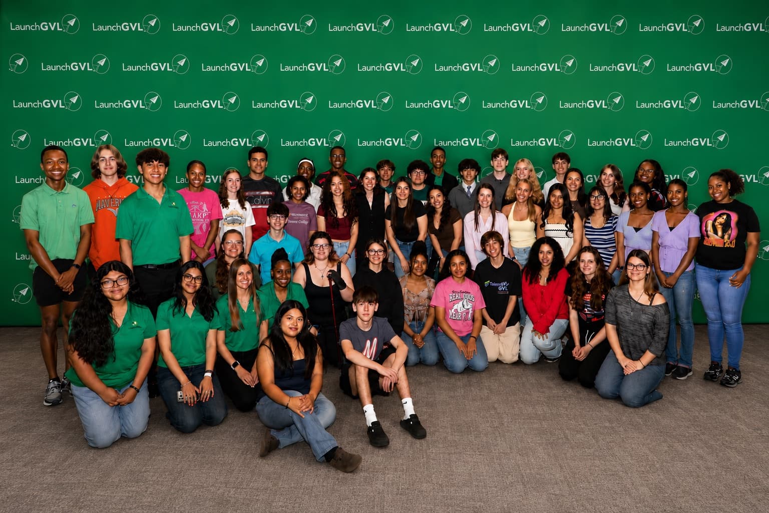 Students from the LaunchGVL program together in front of a LaunchGVL backdrop